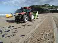 Oil Spill cleanup on beach with beach cleaning machine