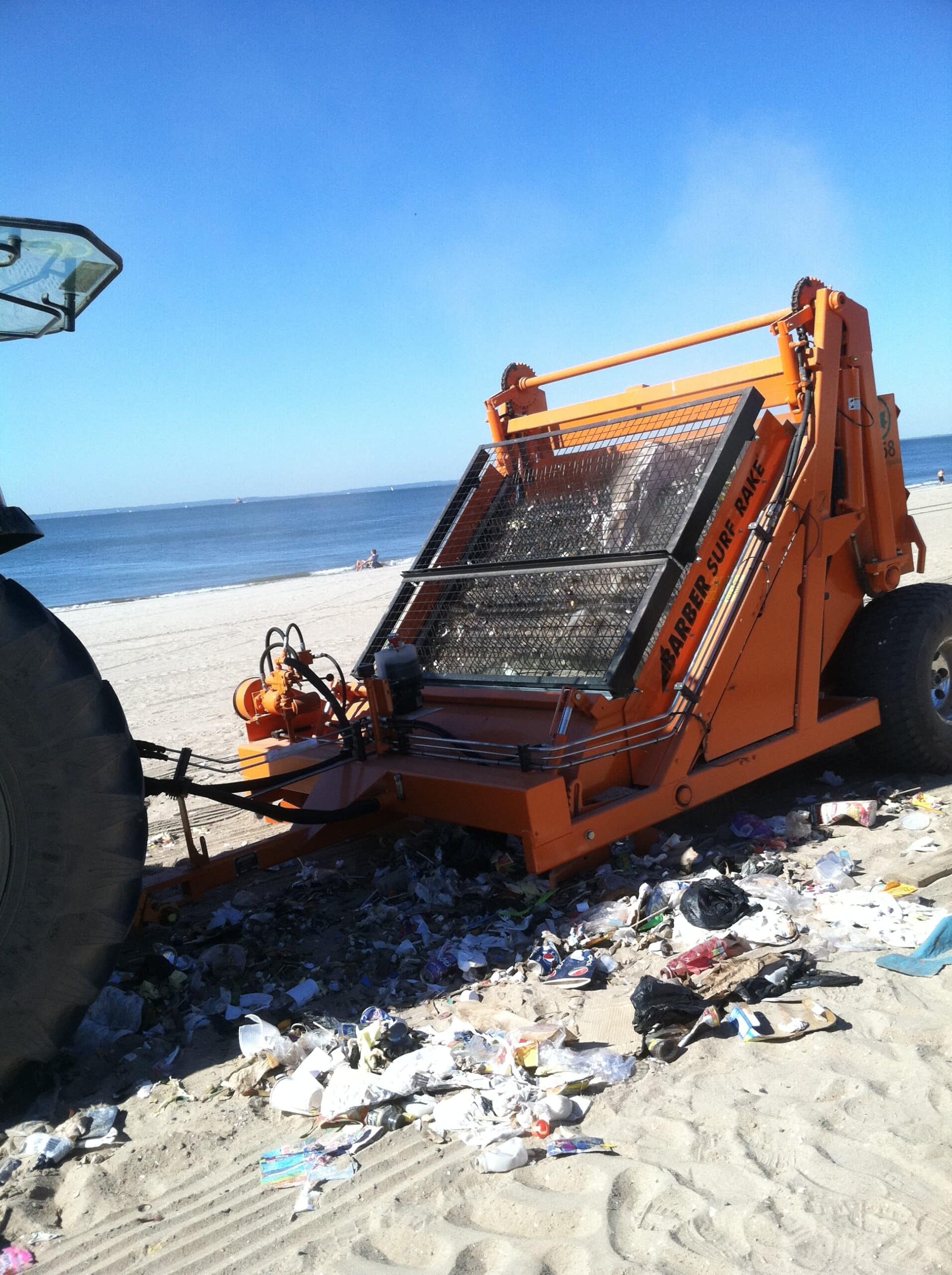 surf rake removes litter from beach at Coney Island ny
