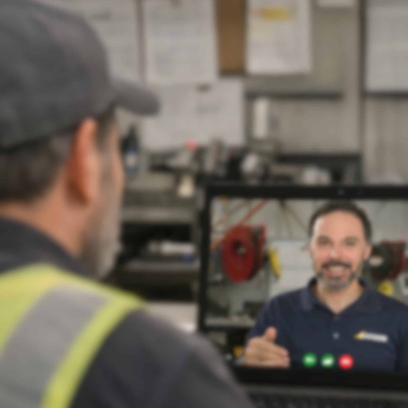 beach manager talking with barber team member on a computer