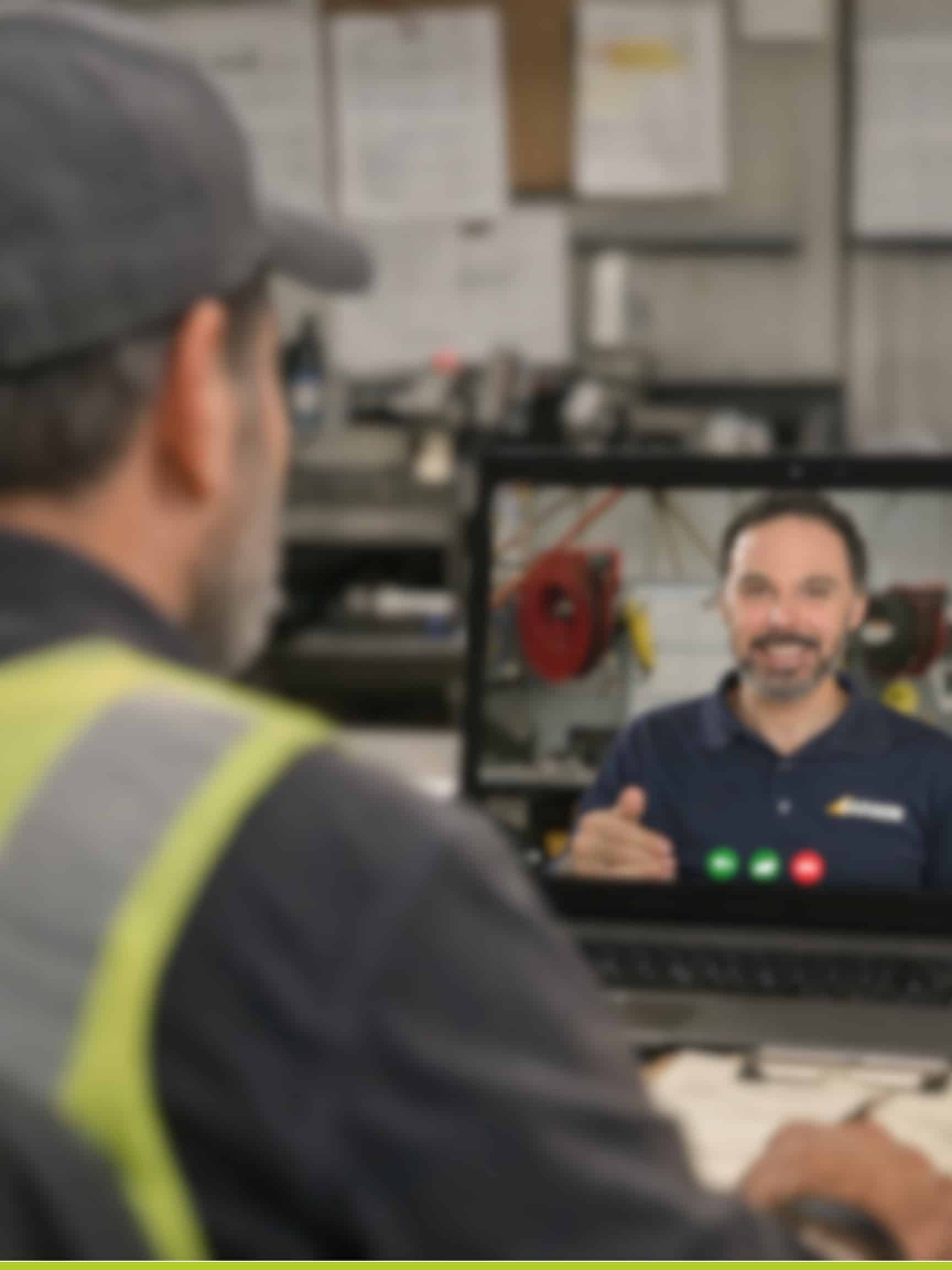 beach manager talking with barber team member on a computer