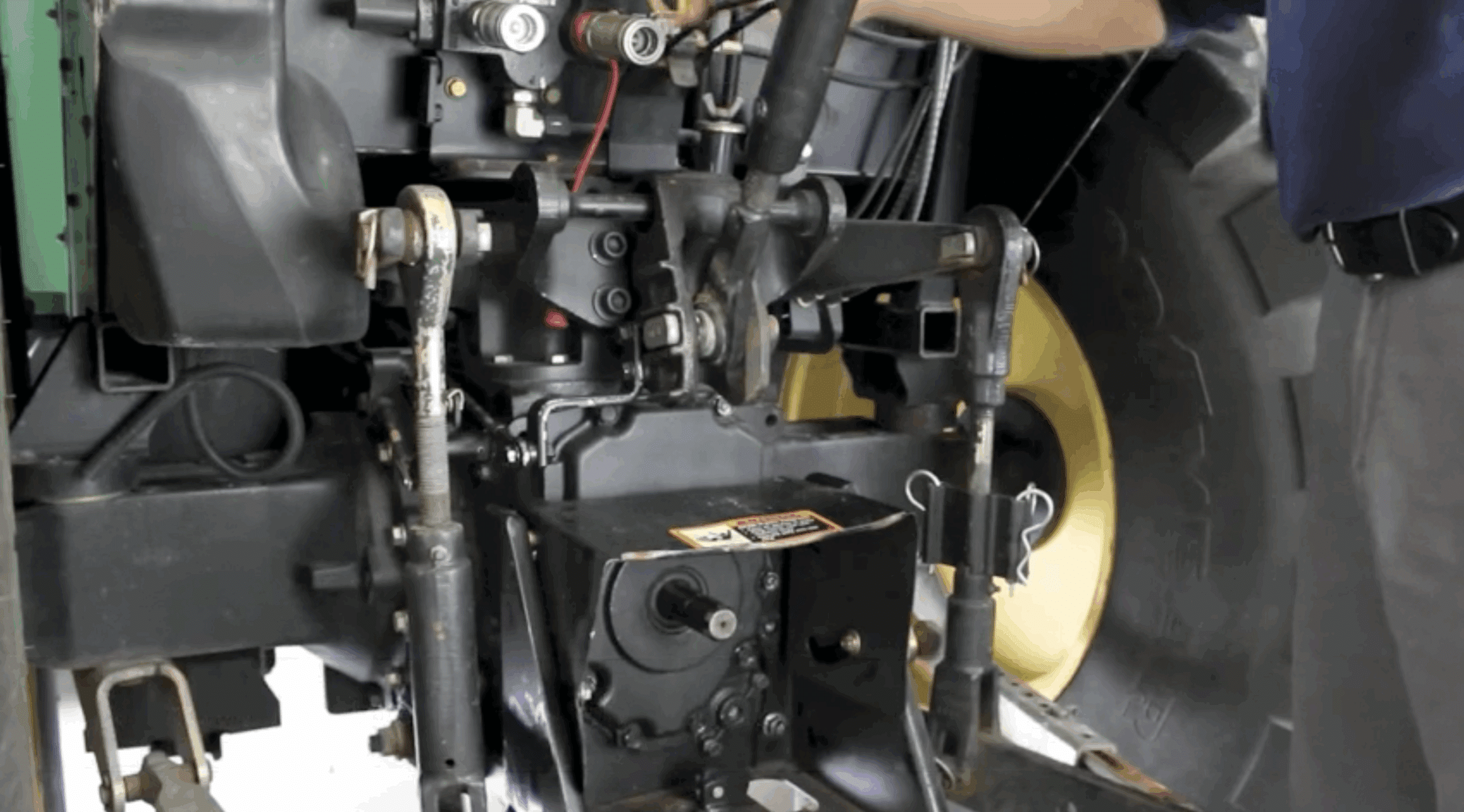 Remove the top three-point hitch arm