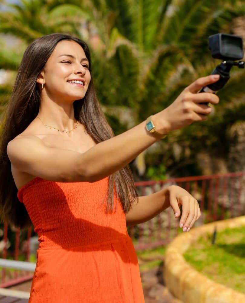 influencer recording video at beach