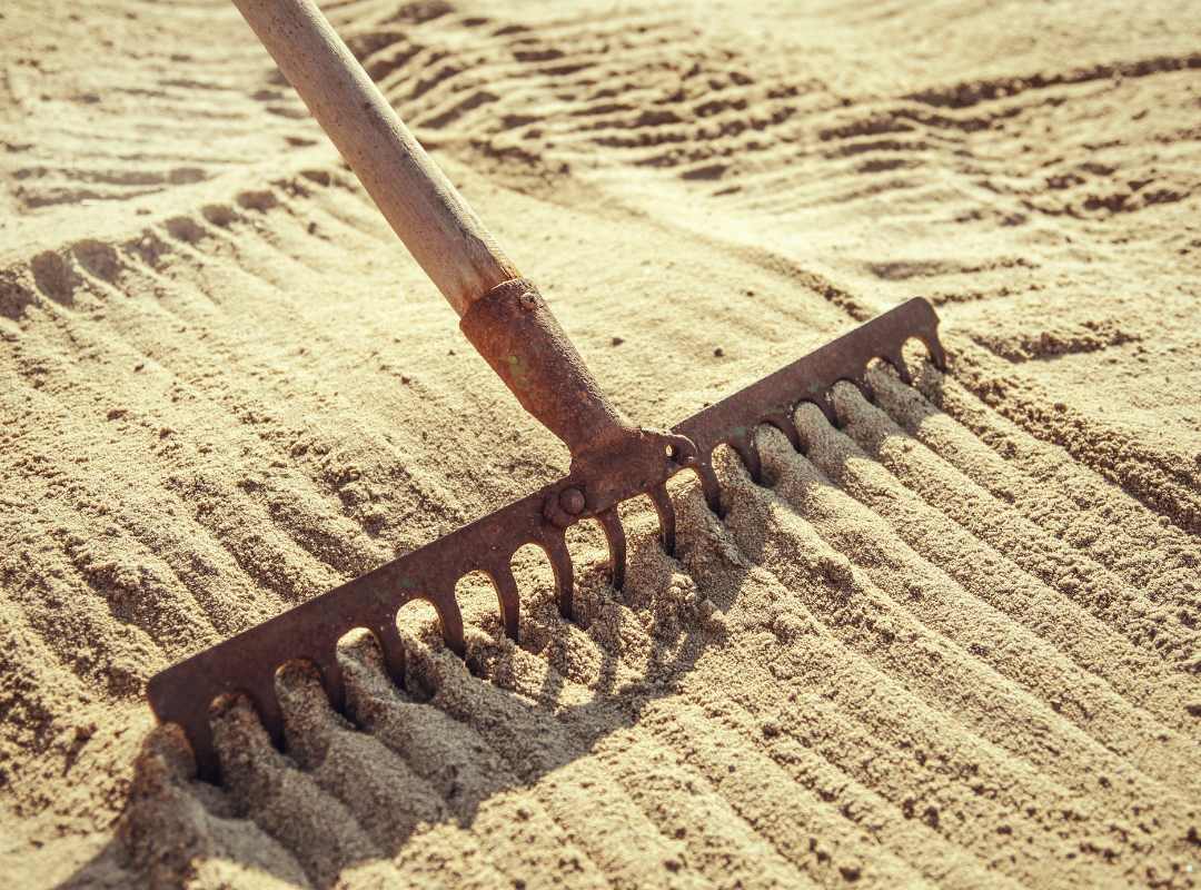 raking through sand