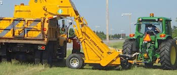 litter picker dumping trash into truck