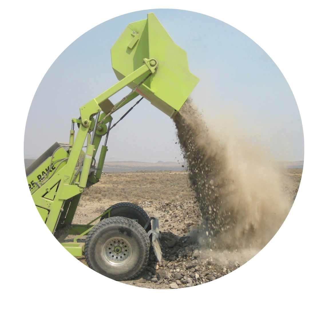 turf rake dumps stones into pile